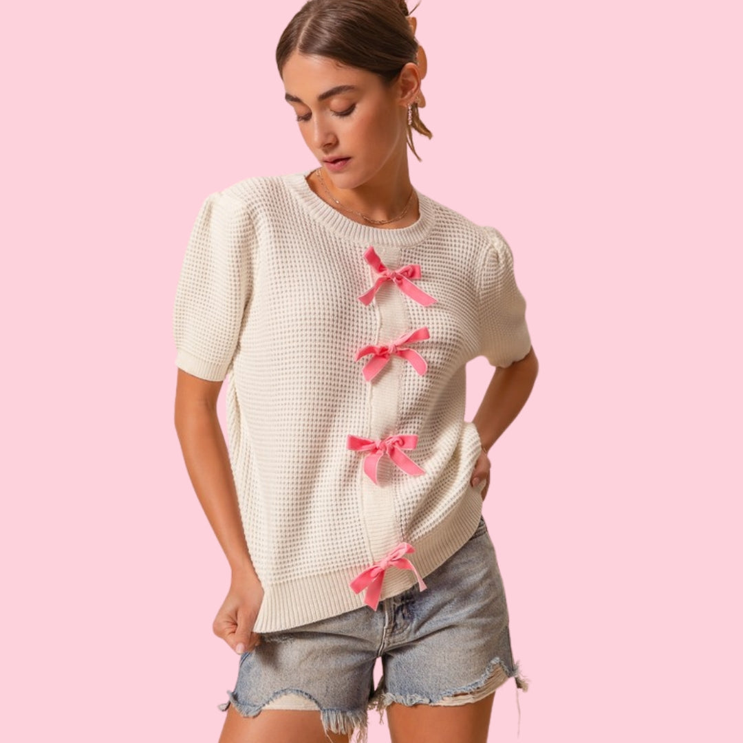 Textured sweater knit top with velvety ribbon trim on the front, offering a chic and sophisticated look with comfortable knit fabric, perfect for elegant and casual outfits.