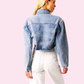 Justine Denim Crop Jacket featuring long sleeves and a high-low length, offering a stylish and versatile layering option for any outfit.