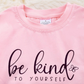 Kids pink ruffle sleeve sweatshirt with 'Be Kind to Yourself' message, featuring soft fabric and playful ruffles for a stylish and comfortable everyday outfit.