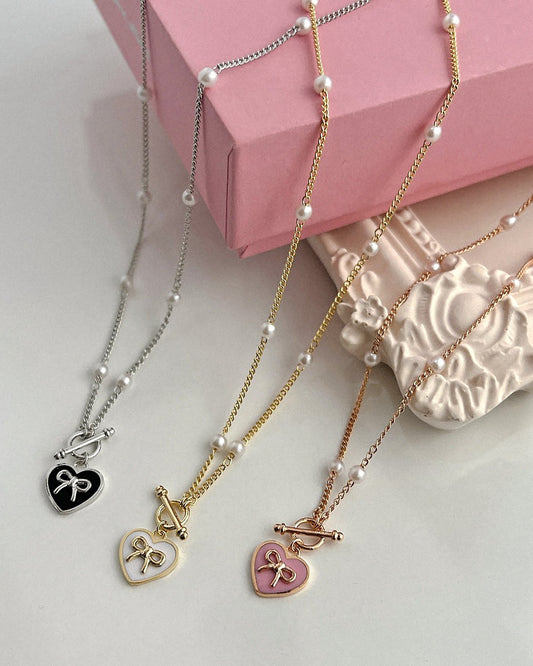 KOKOA Heart-Shaped Charm Necklace with Ribbon Decor and Pearl Beads – Elegant, Stylish, and Timeless